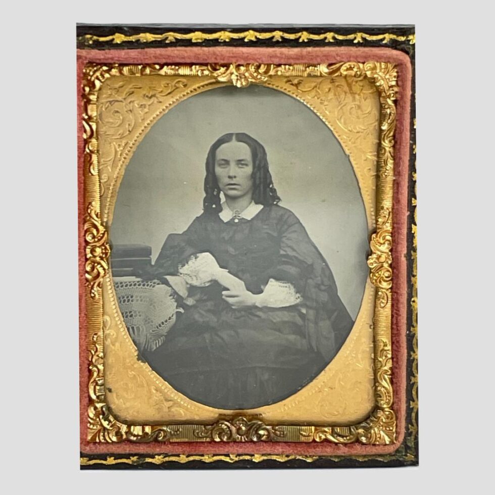 Close up photo of the image of the Victorian lady and the lovely gilt work.