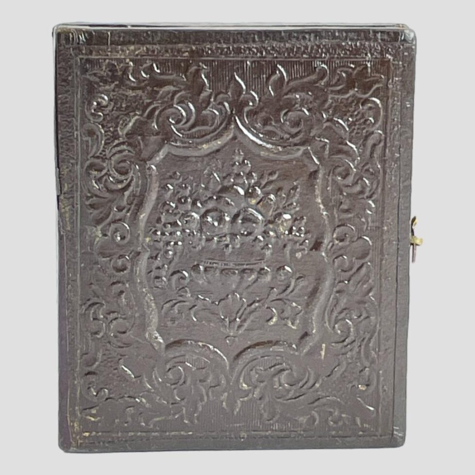 Photo of the front cover of the daguerreotype showing the intricate embossed design of the leather.