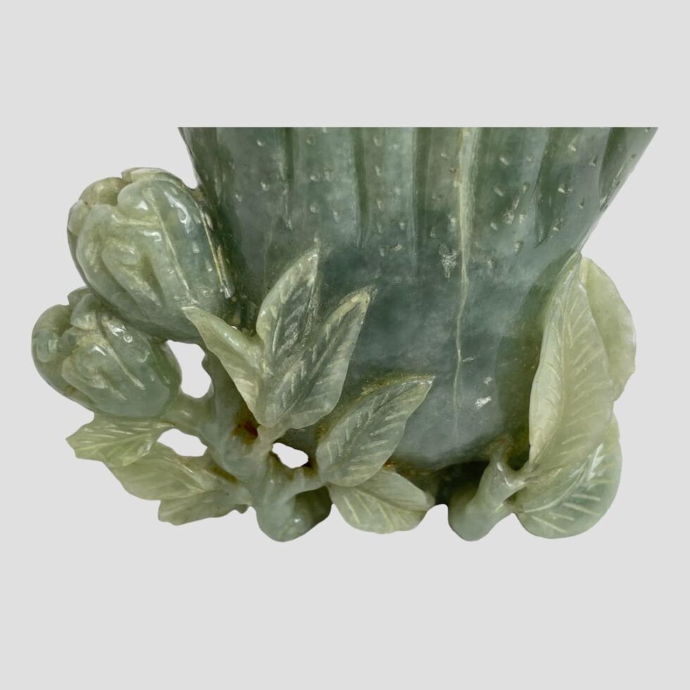 A close up photo of the flowers and leaves at the base of the pot.