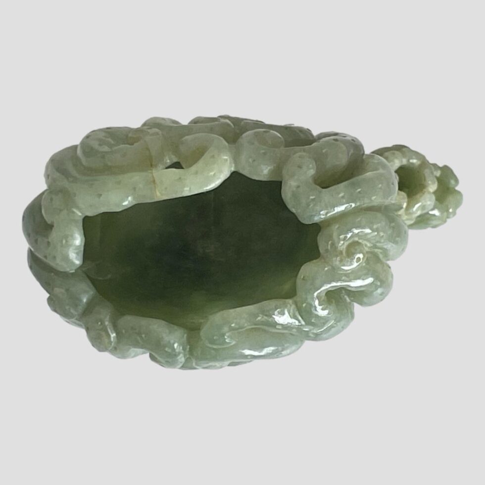 Photo of looking straight down into the mouth of the pot from above. The pot is not a simple straight one so curves in on one side.