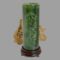 Main photo of jade brush pot &stand displayed standing on its dark lacquered wood stand and with the carved scene side on show. The spinach green jade and dark wood stand are very complimentary together. There is a rock of natural desert sand rose in thew background.