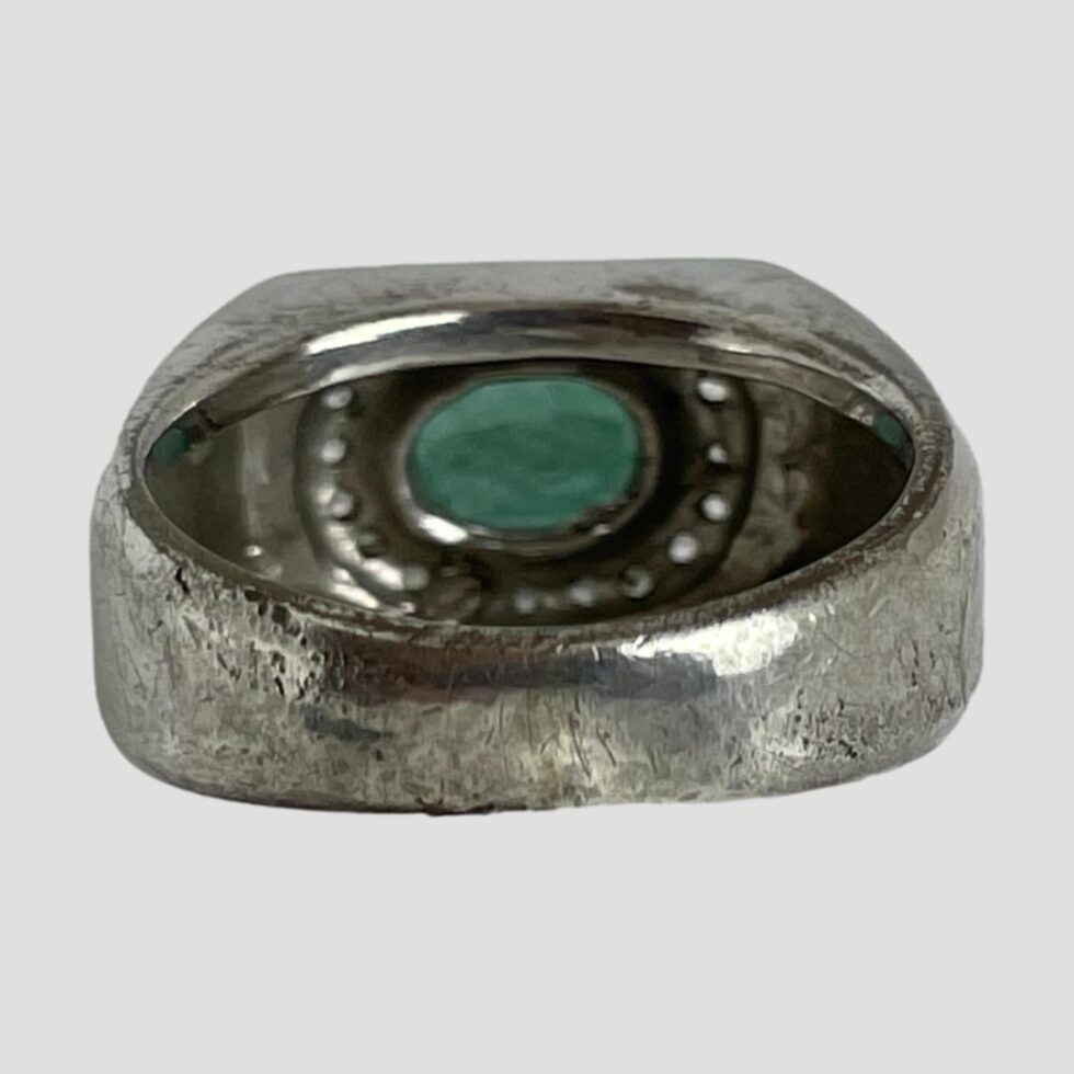 Photo of the back of the ring showing the stone setting for the emerald and the thickness of the band.