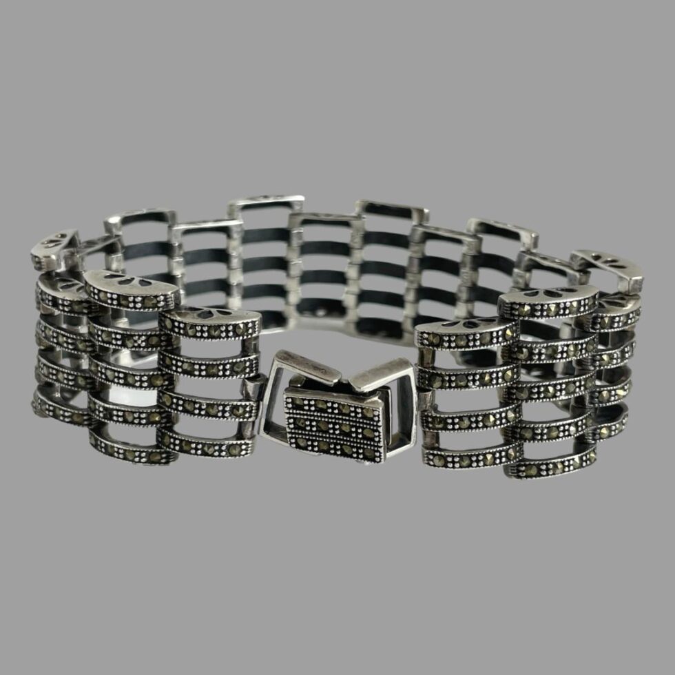 Photo of modern silver marcasite bracelet displayed upright with the clasp closed and in the centre foreground.