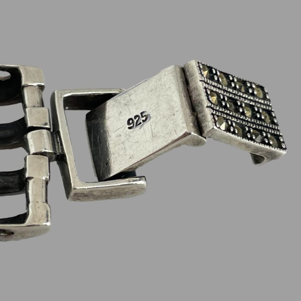 Close up photo of the back of opening clasp shown open with the 925 hallmark on display.