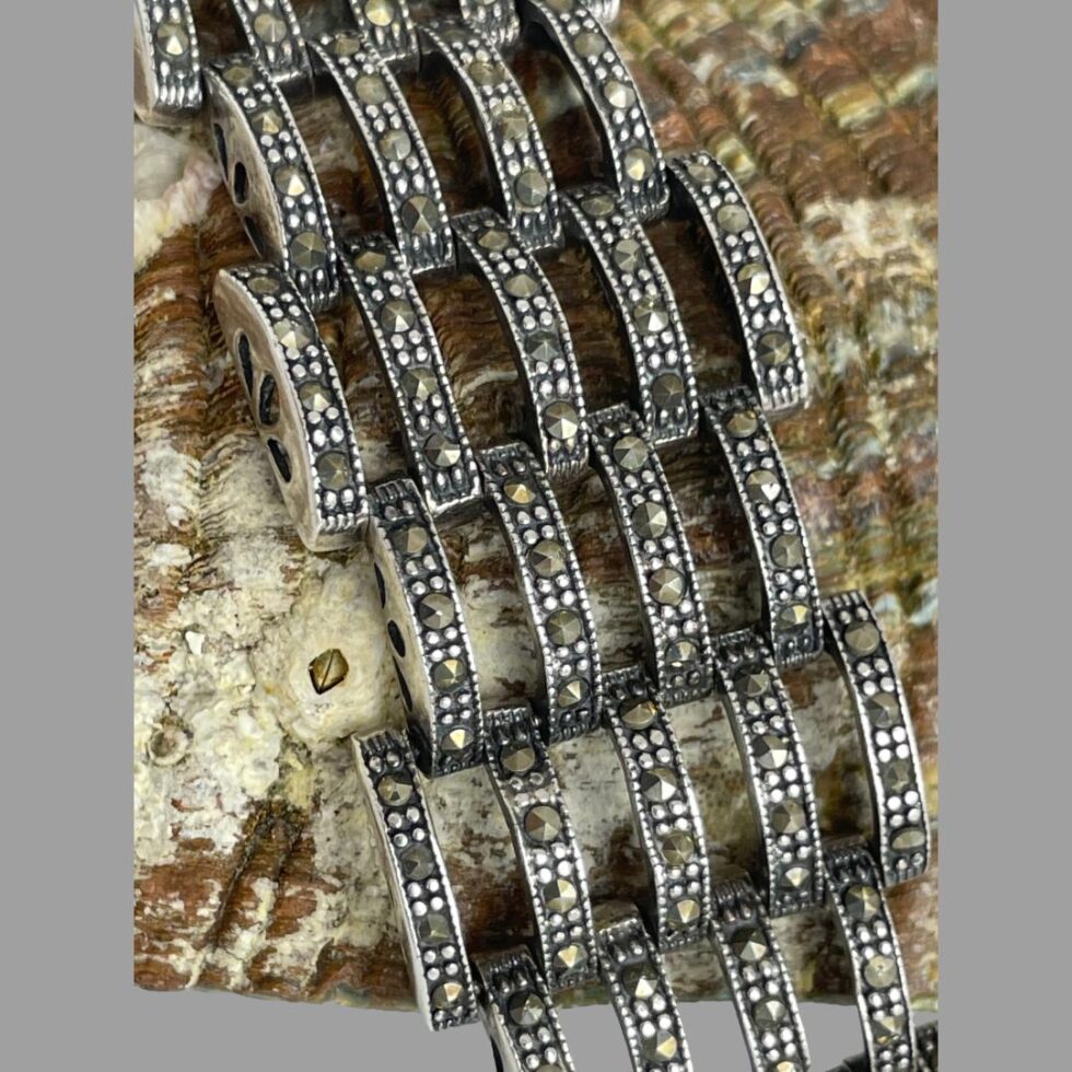 Close up photo of some of the gate panels of the bracelet showing the pewter coloured marcasite pieces.