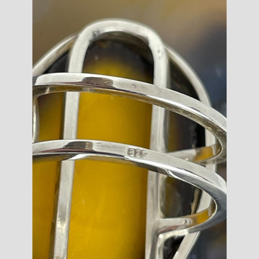 A close up photo of the 925 hallmark on the outer band of ring.