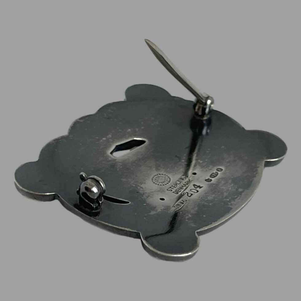 Photo of the back of Jensen dove brooch this time showing the pin open