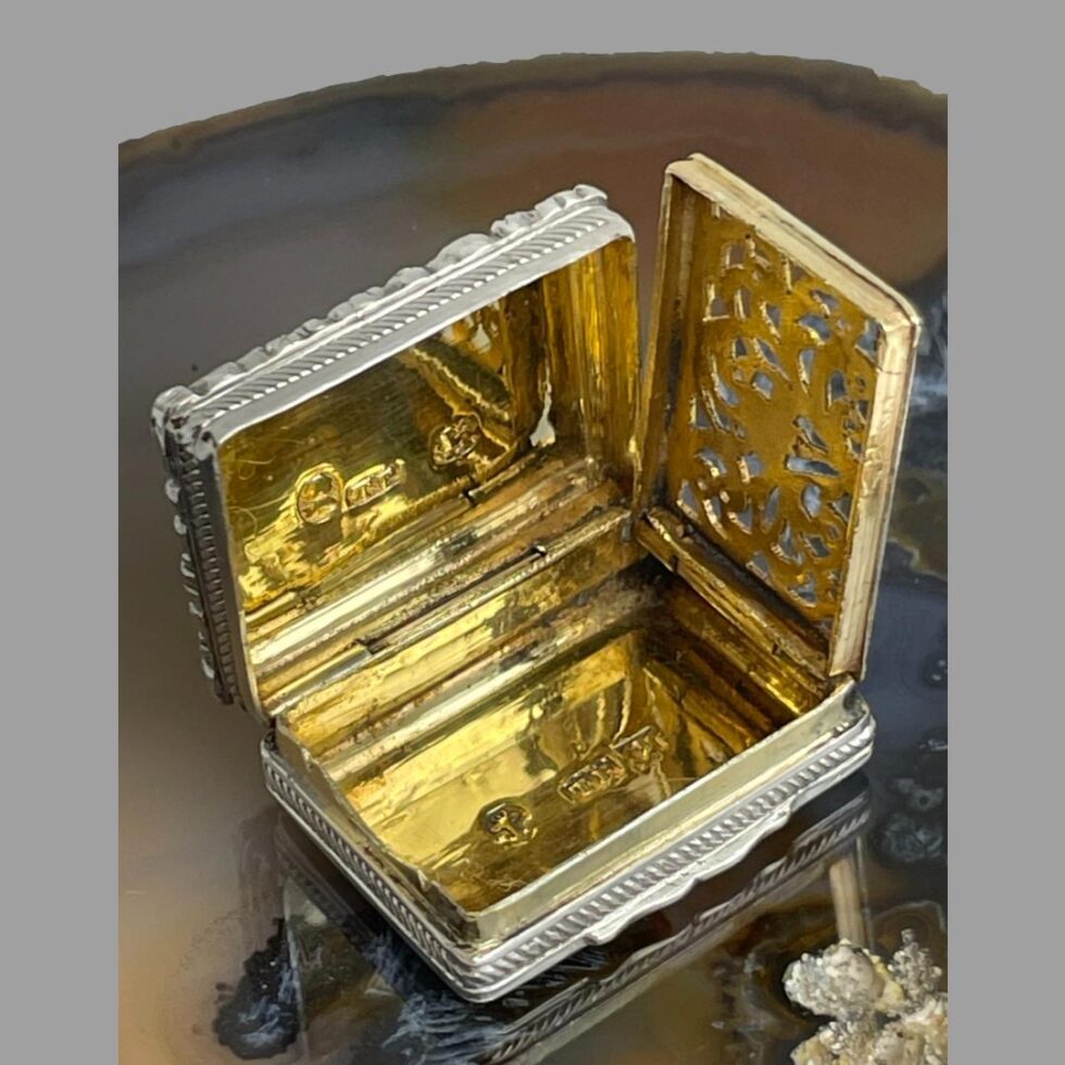 Photo of Edward VII silver vinaigrette displayed open with the grill also opened. The full gilt interior is displayed along with the hallmarks on the inside lid and bottom of the case.