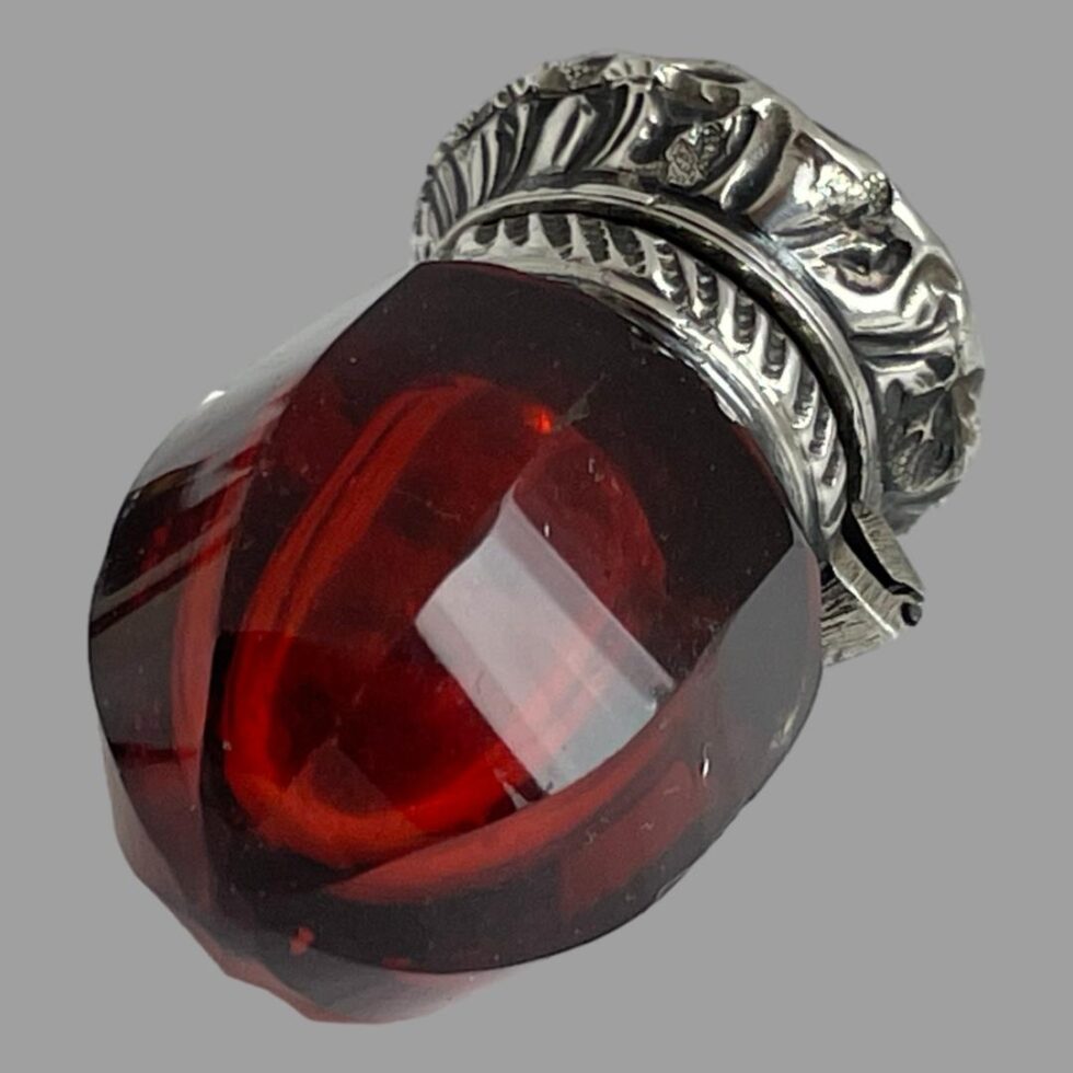 Photo of smelling salts bottle seen with the pointed bottom of the glass bottle in the bottom left foreground.