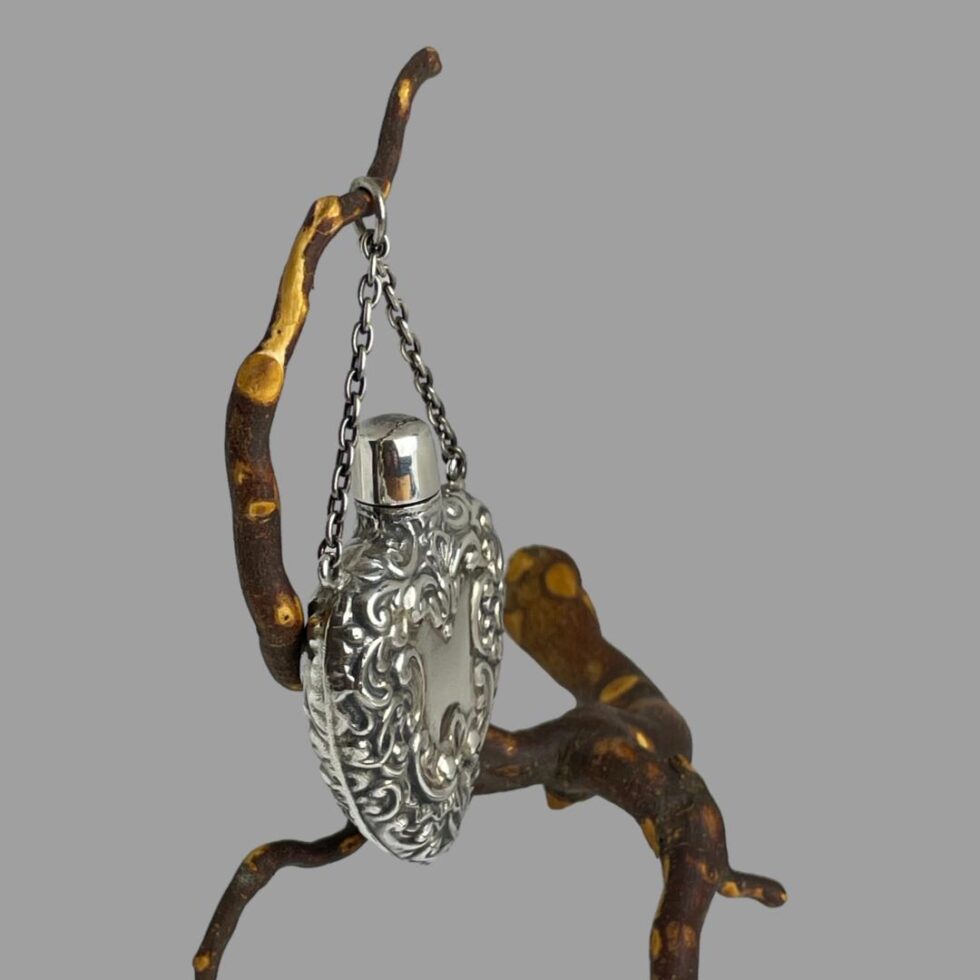 Photo of the heart scent bottle still hanging from a twig this time seen from a side angle showing the depth.