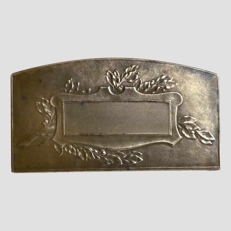 Photo of the back of the French bronze football medal showing the laurel branch across the centre of the medal with an empty rectangular cartouche laid over the top.