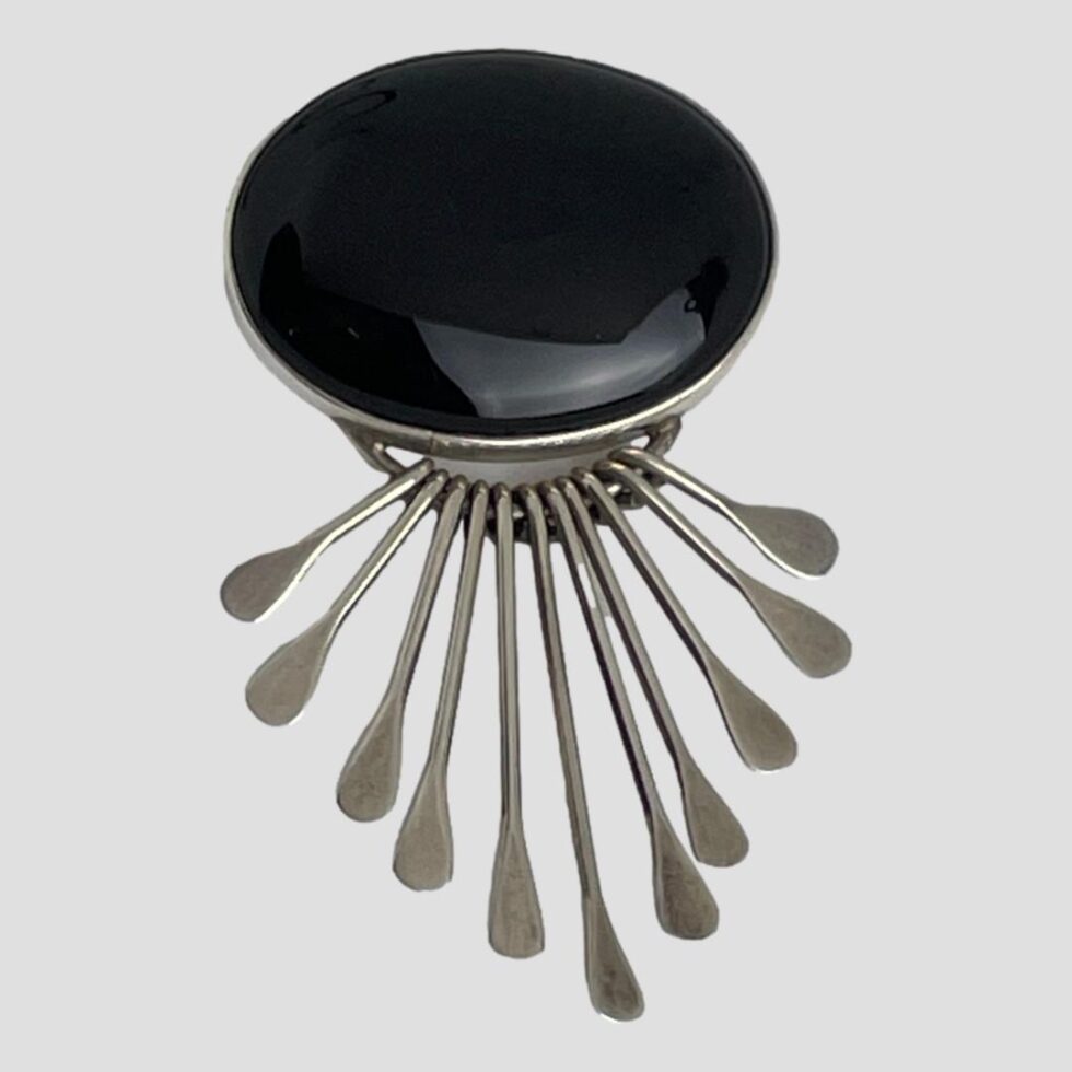 Photo of the onyx brooch pendant with the silver strands fanned out to show they are fluid and not solid.