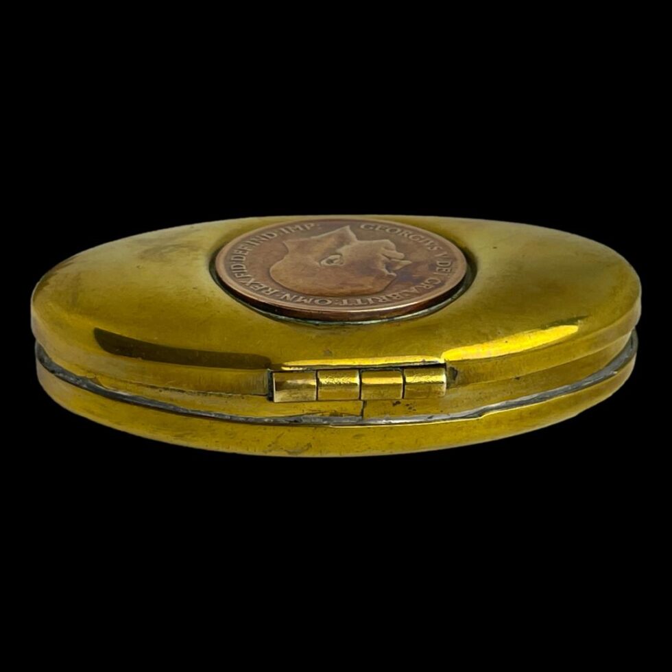 Photo of the hinged back area of the brass miners snuff/twist box shown closed.