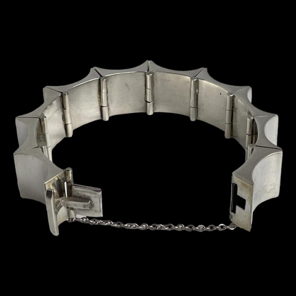 Photo of the Taxco bracelet with the clasp area in the foreground and shown open with safety chain extended out fully. A nice touch to this bracelet is the letter T shaped gap where the clasp slots in to close. T for Taxco!