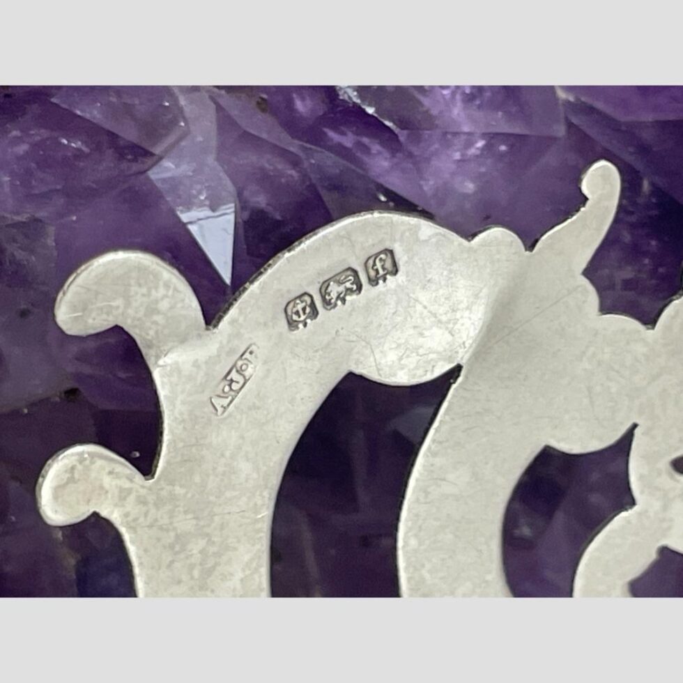 Close up photo of the full hallmark on the back of the Edwardian hair comb.