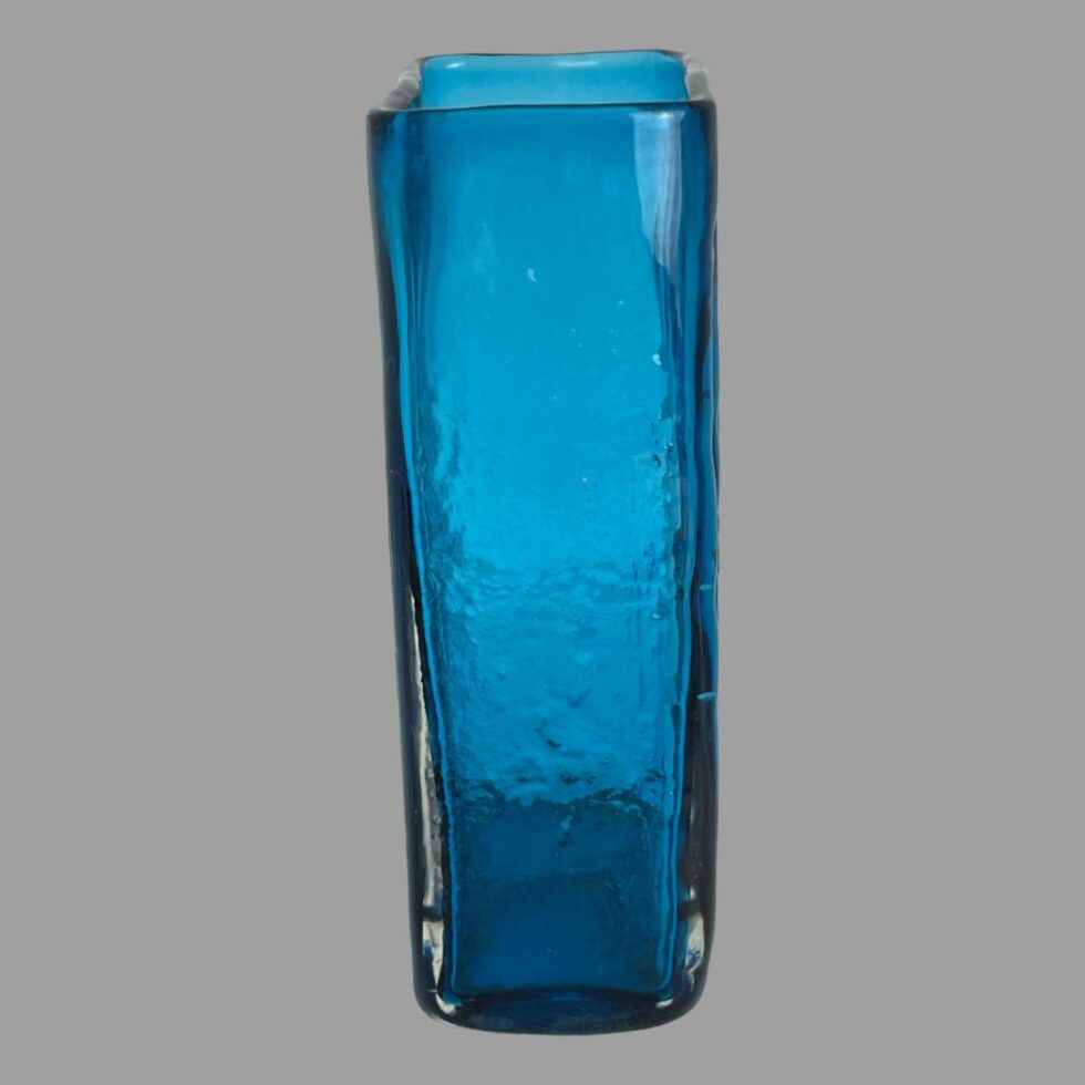 Photo of the side of Whitefriars bamboo vase. The sides as well as the back are all smooth glass..