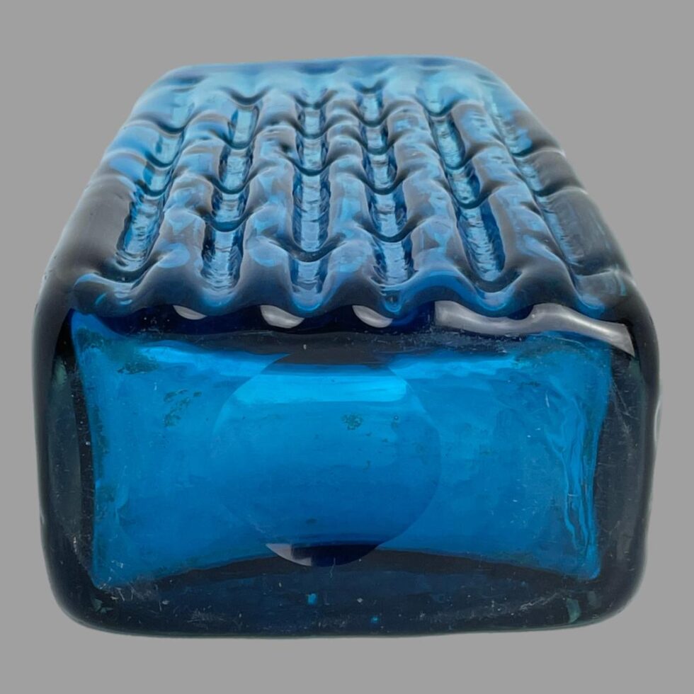 Photo of Whitefriars vase laid flat on its back with the bamboo side at top and showing the base.