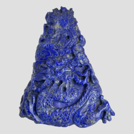 Main photo of vintage carved lapis dragon displayed with the front of the dragon on display. The tip of the dragons tail is at the top of the carving with its front legs on the bottom left and right. The Oriental dragon has a long snakelike body, this one winds around the pyramid shape, reaches the bottom and is now back on the ascent. Its head is near centre of the carving front and looking up to the summit. A lovely gift item.