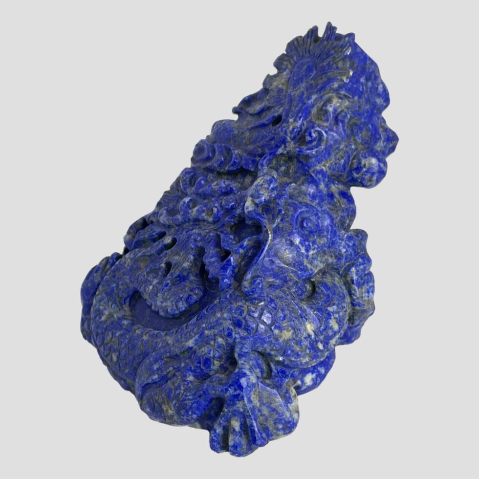 Photo of carved lapis dragon turned slightly to the left with the front side facing left.