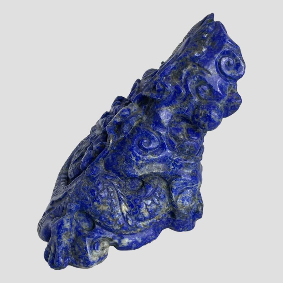 Photo of carved dragon now facing full left. The lean of the piece is evident here with the slant across the top right to the bottom left.