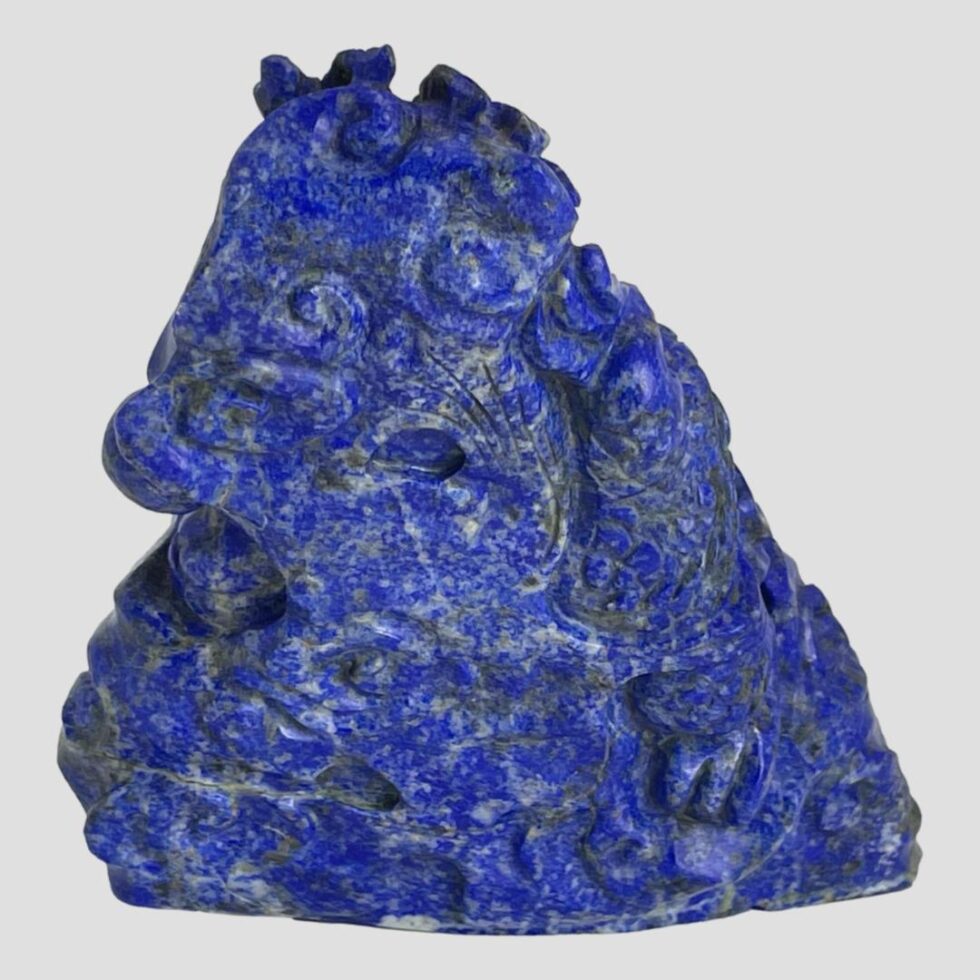 Photo of the back of the lapis dragon where there is minimal carving but some parts of the dragon visible.