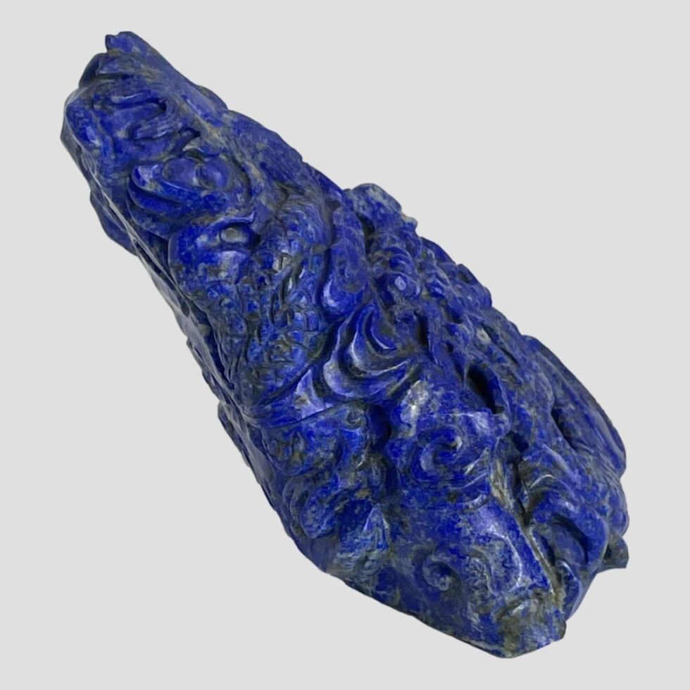Photo of the lapis dragon now faced to the right. The lean of the piece appears more acute from this angle.