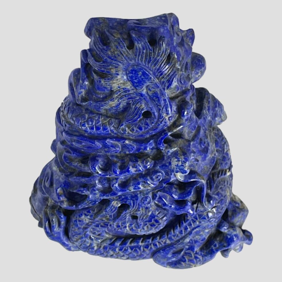 Photo looking down at the vintage carved lapis dragon from above. Due to its extreme lean, it is possible to see the carving even from this angle.