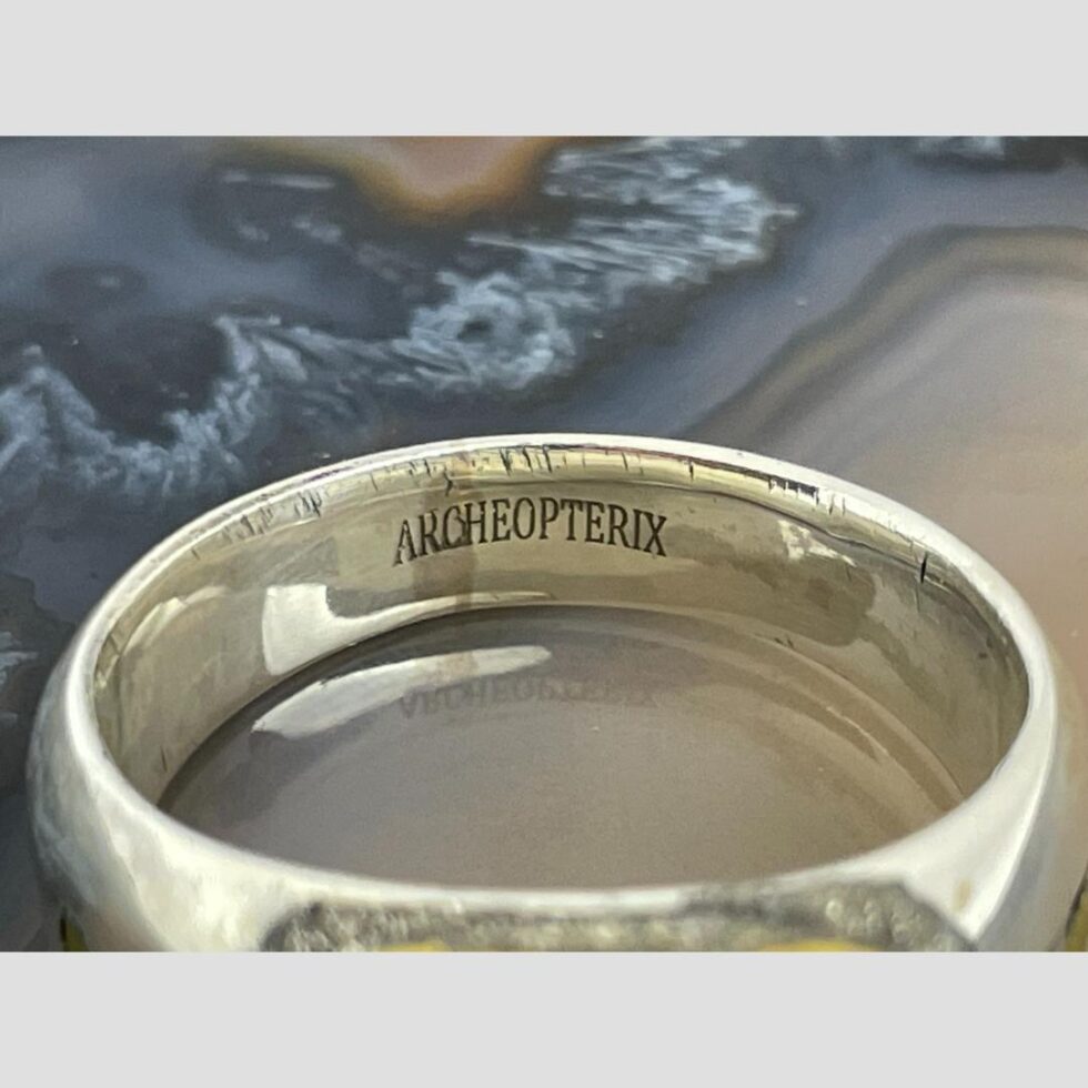 Close up photo of the designers stamp on the inside band (Archeopterix)