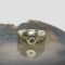 Main photo of upcycled Medieval fragment ring displayed on top of a slice of natural agate with the ring front facing forward. The crescent moon is set across the top of the circular bronze centre with the star underneath it. The bronze fragment extends on either side to make the shoulders. These areas have some embossed detail of possibly vines. The band is in solid sterling silver and the plainness of it compliments the Medieval bronze fragment perfectly.