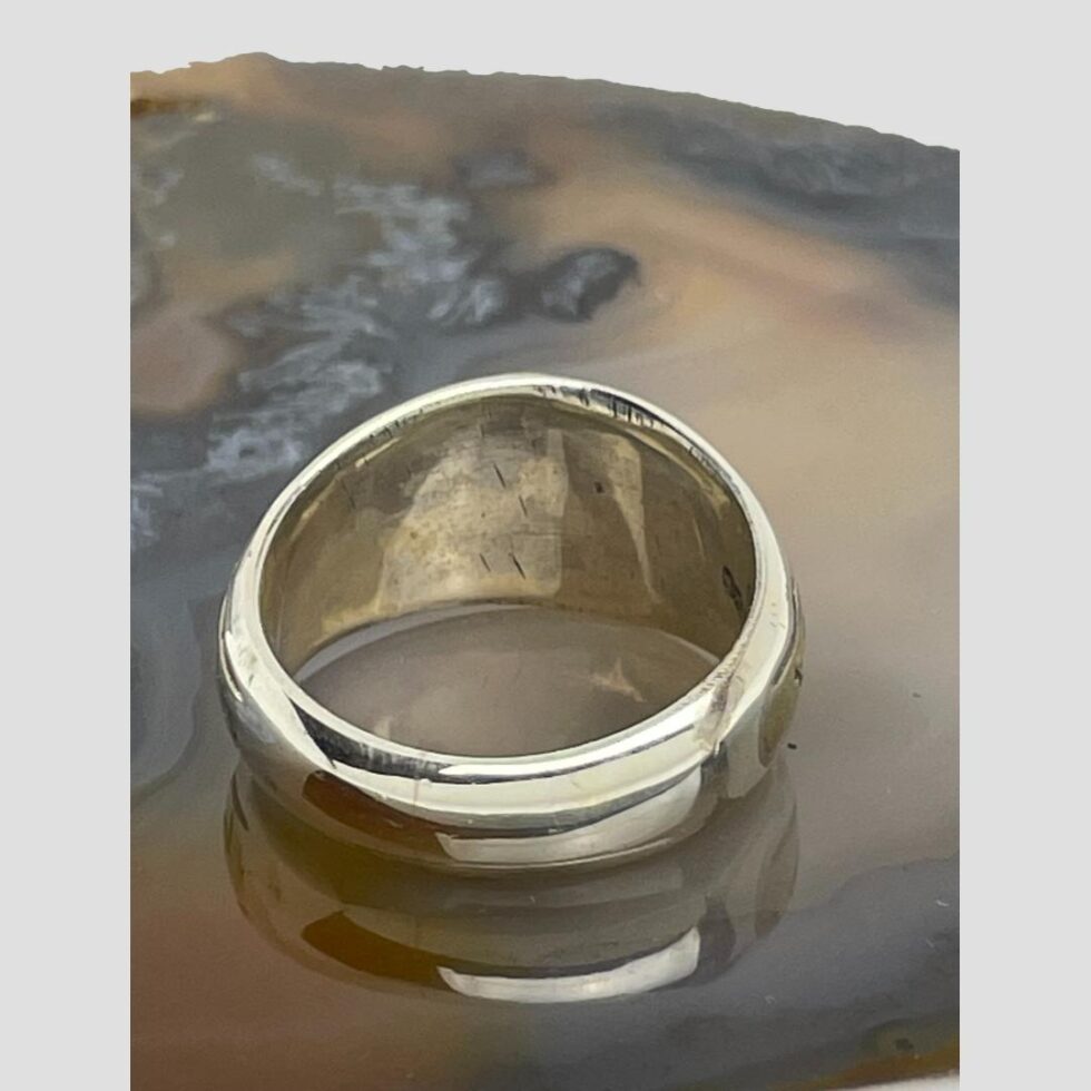 Photo of the back of the ring. The area behind the bronze Medieval fragment is visible with only solid sterling silver showing.