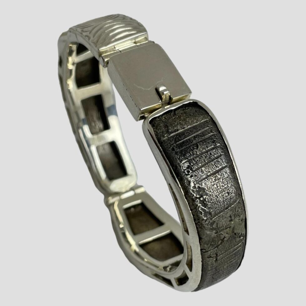 Photo of eternal snake bracelet displayed upright with the clasp area on the top.