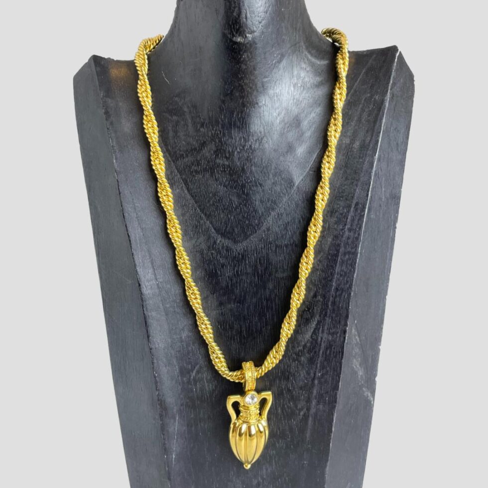 Photo of the amphora necklace displayed on a black wooden stand and forward facing. The chain is a generous length which should suit several preferences.