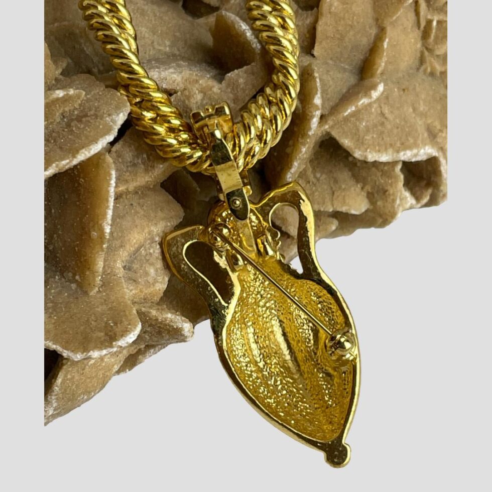Photo of the back of the amphora pendant/brooch showing the bail and the pin which is diagonally set across the back of the piece. No makers marks.