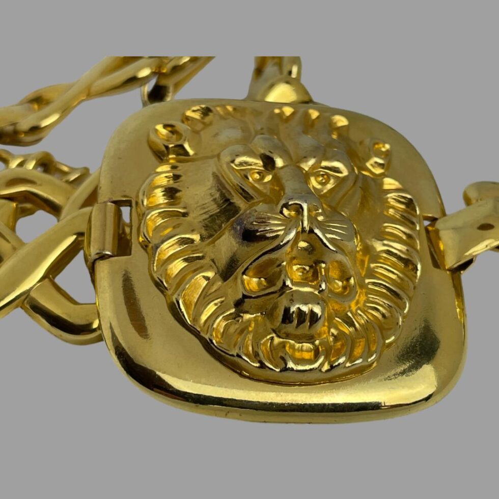 A close up photo of one of the gilt panels with the large lions head.