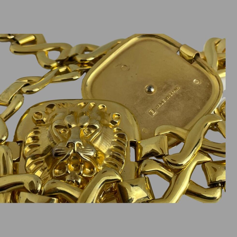 Close up photo showing one panel with large lion head and behind it the back of another panel showing the E mark for Escada and Made In Spain.