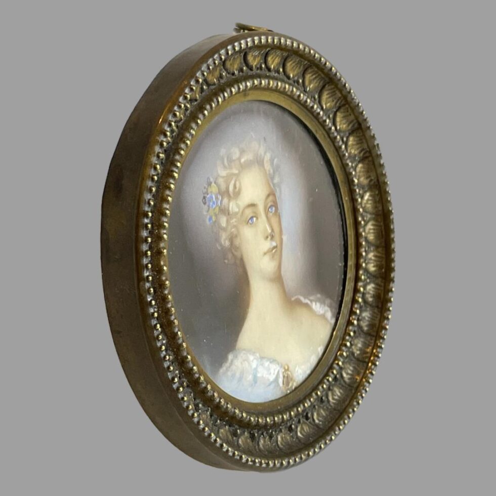 Photo of French miniature facing the bottom right corner. The lady's eyes are still on you!