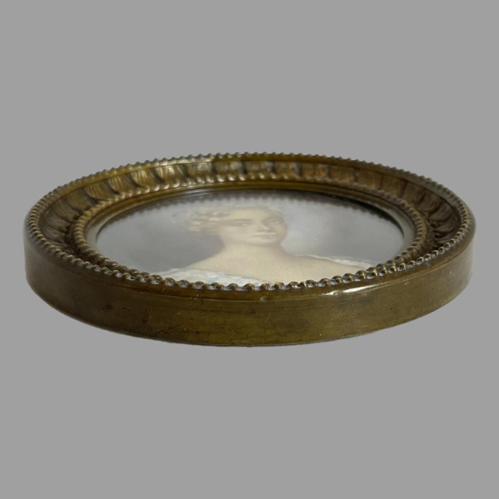 Photo of miniature laid flat showing the depth of the frame. The lady's eyes are still with you.