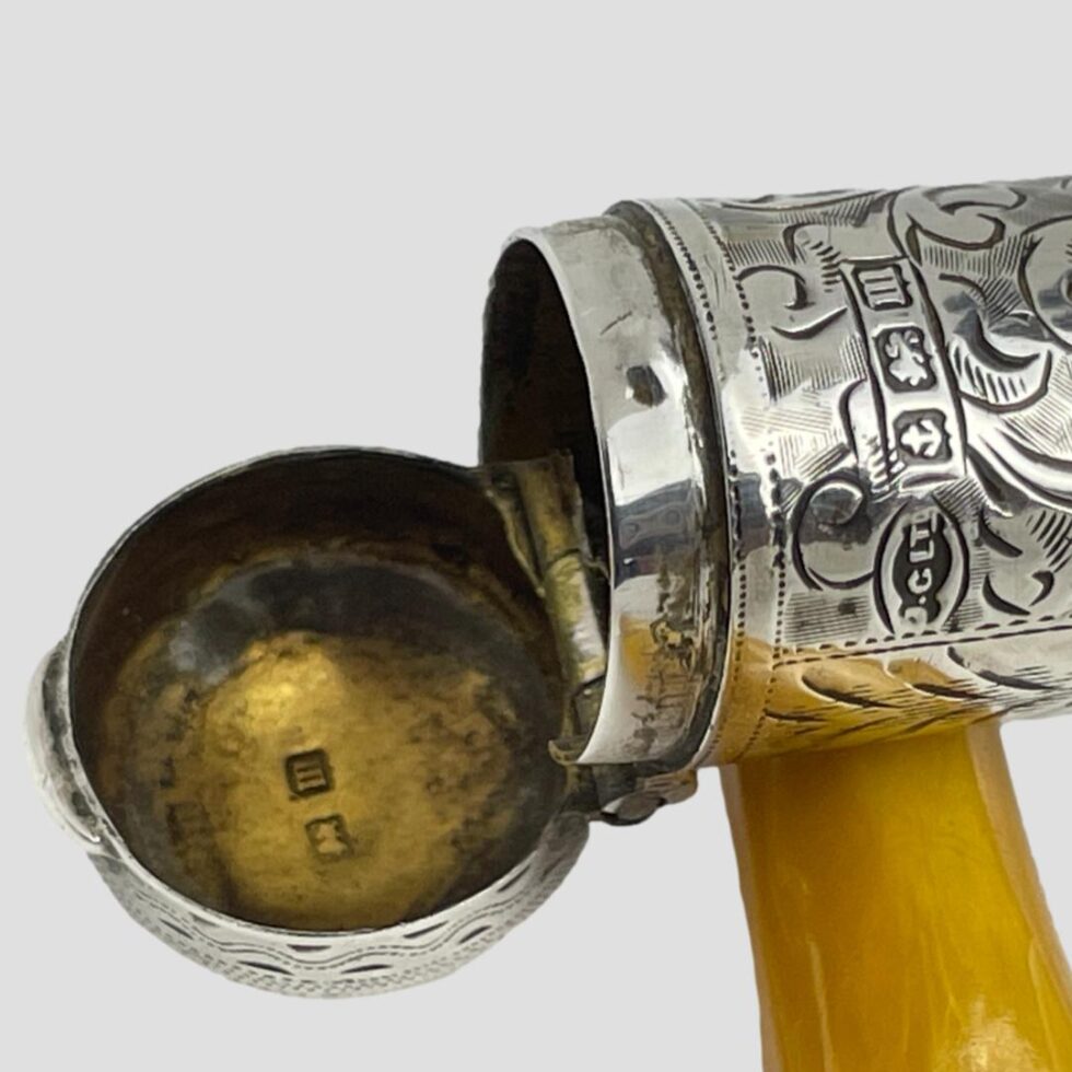 Close up photo of the full hallmark on the outside edge of cheroot case and the short hallmark inside the lid .