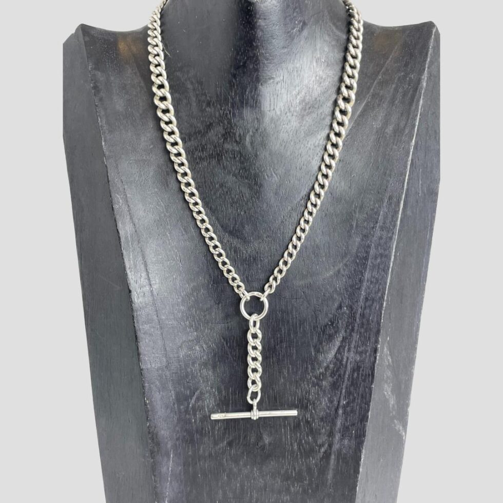 Photo of repurposed antique Albert chain displayed on a dark wood stand which is forward facing. This photo shows how it will look when work although will be shorter on the neck than seen here.