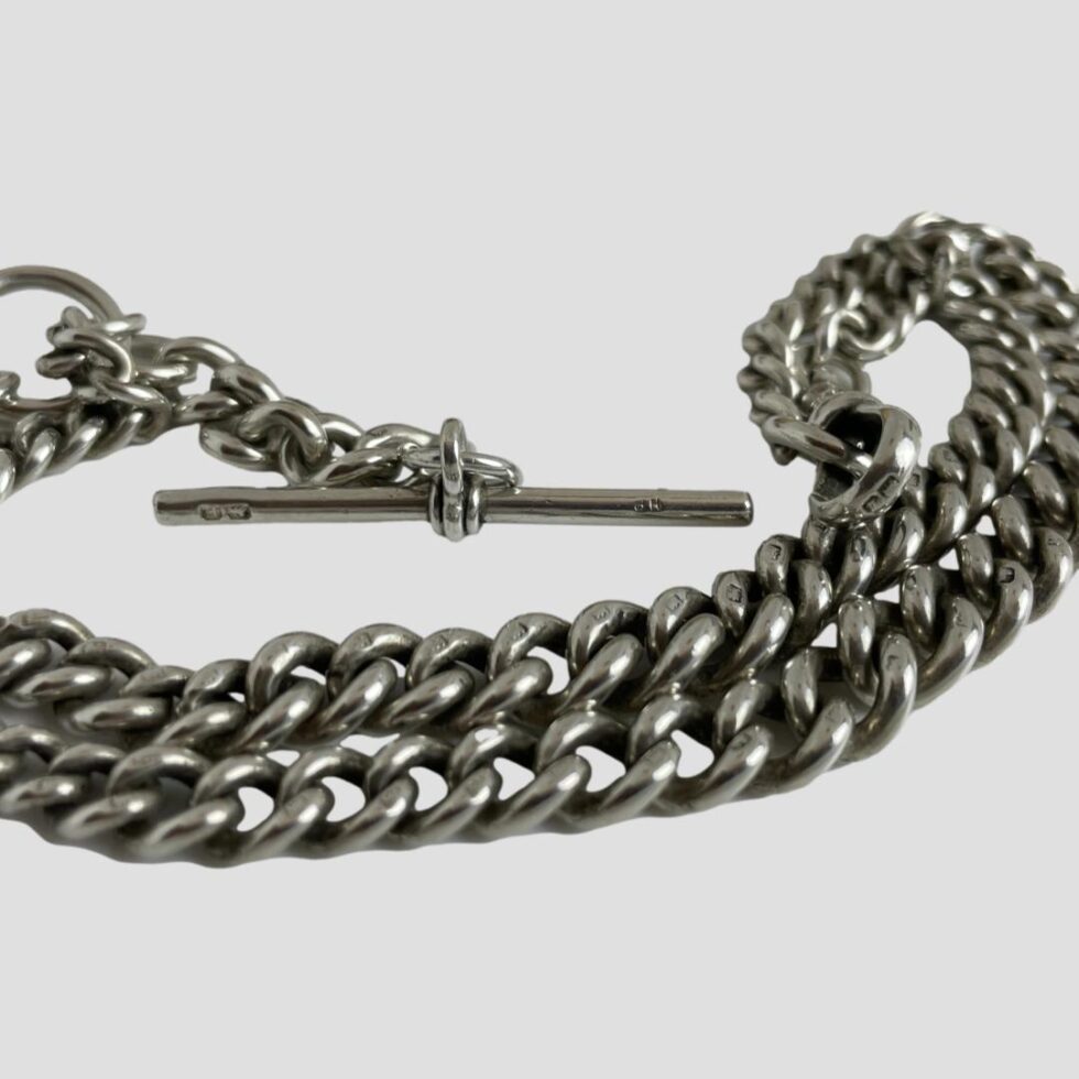 Close up photo showing the hallmarks on the T-bar, the dog clip and each of the chain links shown.