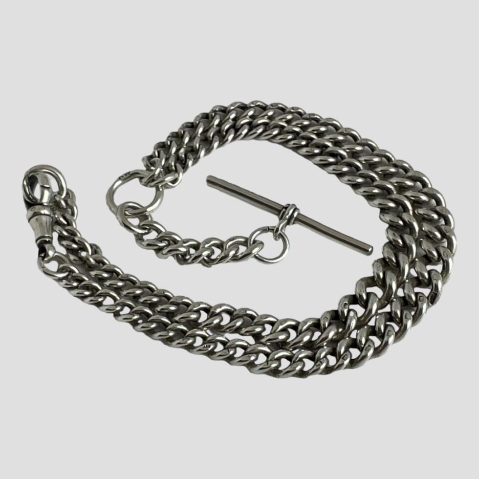 Photo of Albert chain necklace displayed in a coil fashion on a flat surface with the T-bar in the centre.