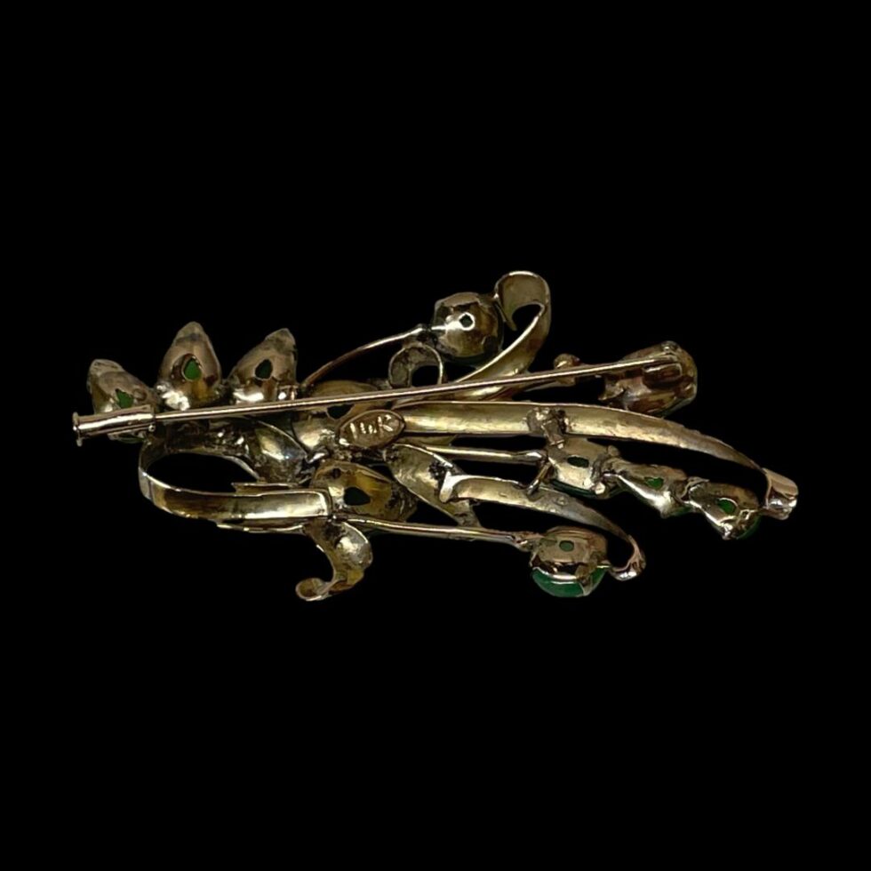 Photo of the back of jade spray brooch shown with clasp closed.