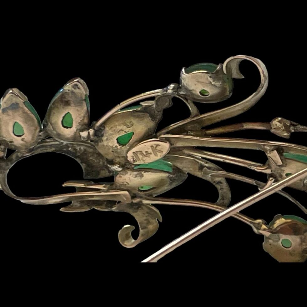 Close up photo of the 14k hallmark to the back of jade spray brooch.