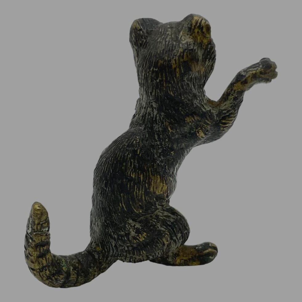 Photo of the small bronze cat in same pose this time viewing from the other side which is the back.