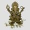 Main photo of antique bronze Lord Ganesh shown against a light grey background and facing forward at the camera. There a spray of white orchids laid around his feet. This bronze has a golden hue and is very well presented.