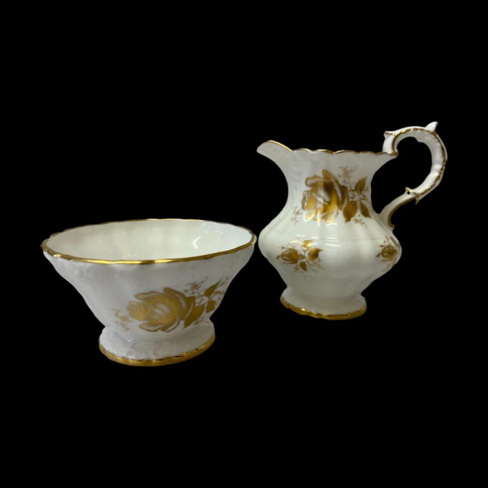 Photo of the sugar bowl (on the left) and jug on the right. The jug has a similar design style to the pot.