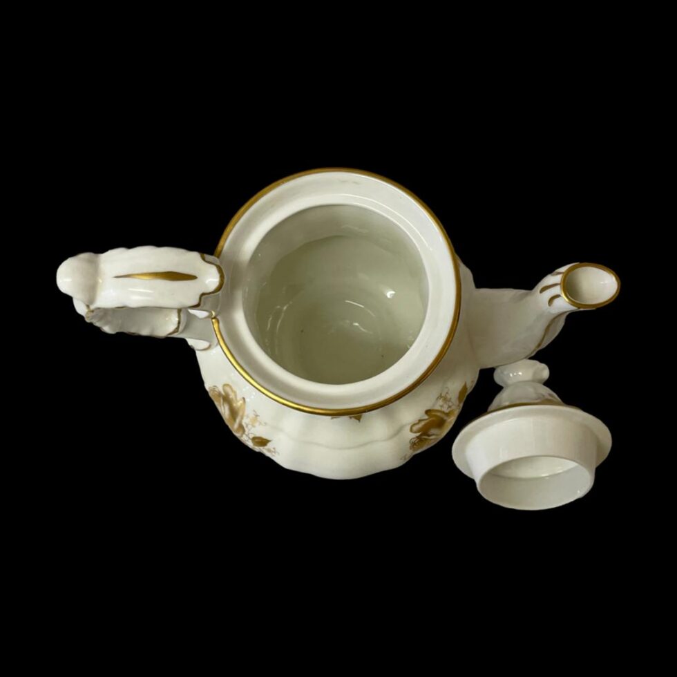 Photo looking straight down into the tea/coffee pot which has its lid removed and placed to the right. The spout is on the right.