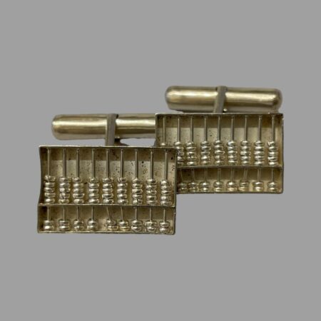 Main photo of 1960s silver abacus cufflinks shown from the front with one slightly in front of the other. These are proper working miniature silver abacuses with moving counters but you will need a pin or toothpick to use it! The bar toggle is visible at the back.