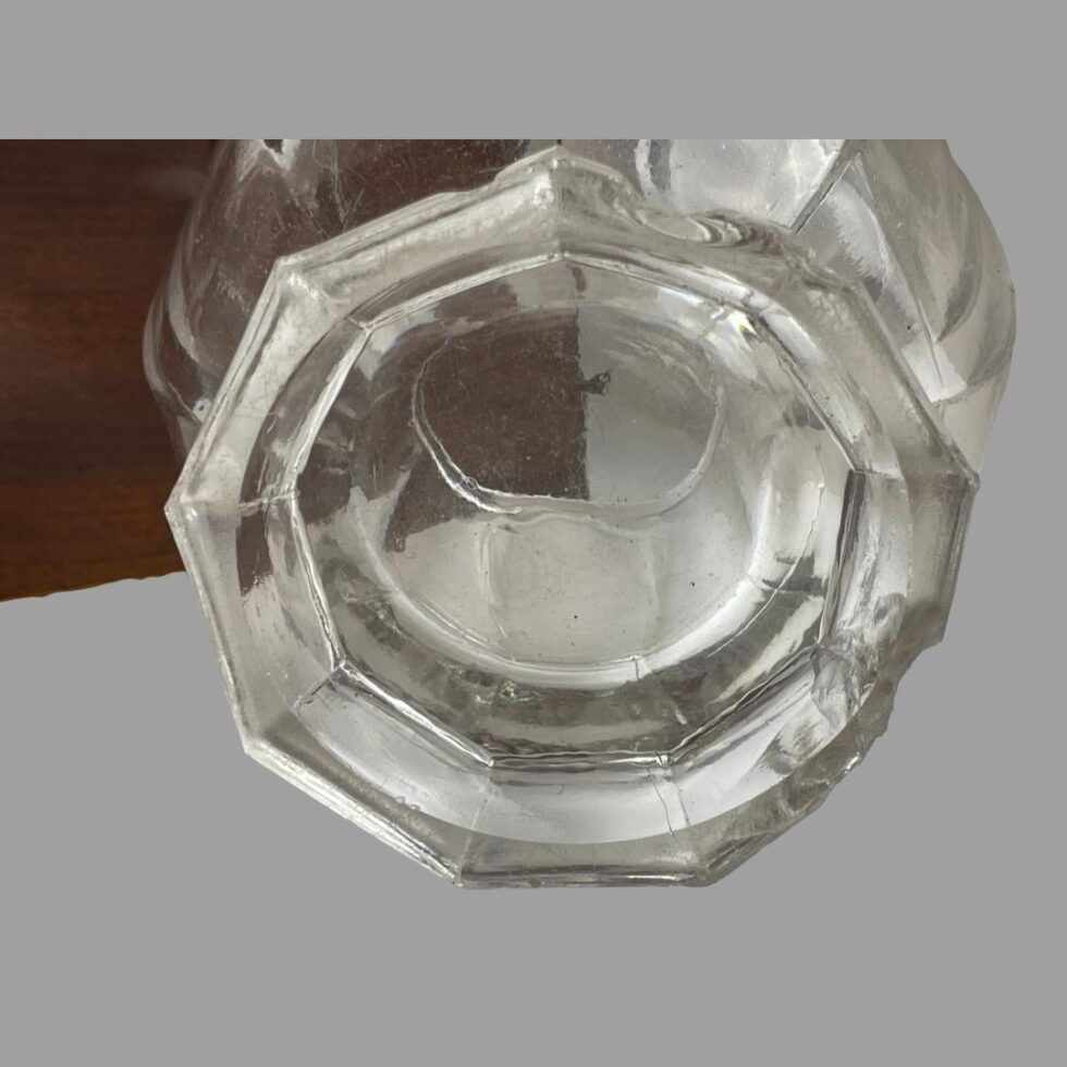 Close up photo of the base of the glass bowl showing the chips to the base.