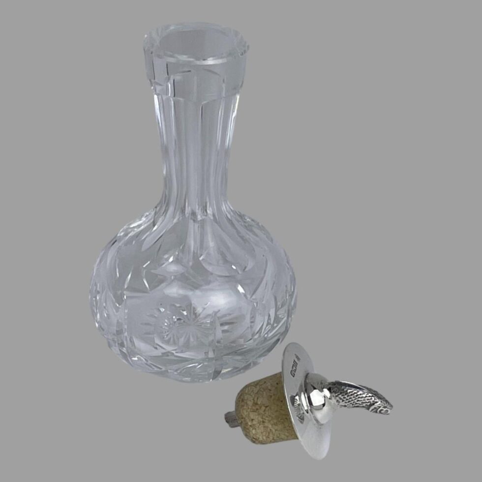 Photo of the cut crystal silver topped bitters bottle with the silver top with cork stopper removed. The cork has no colour staining and looks brand new.